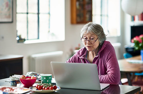 Woman with glasses working on laptop