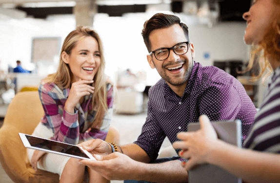 Group of young professionals reviewing their Aware Super options together on a tablet