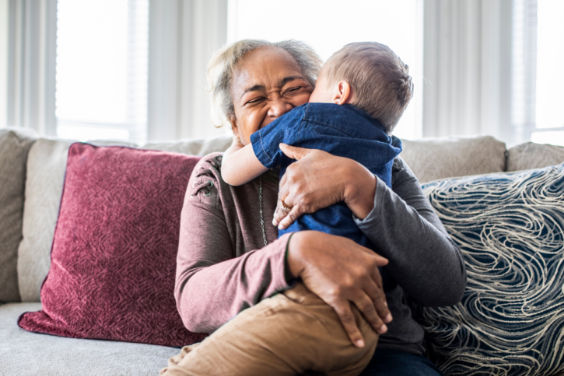 Mature woman hugging child