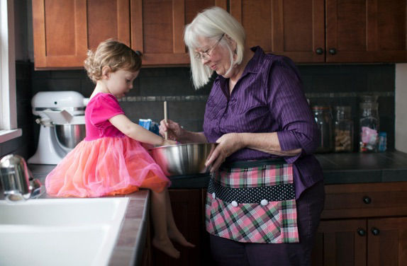 older lady and child making cake